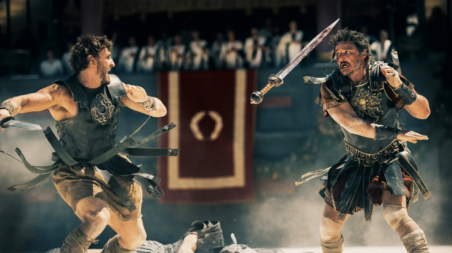 Two gladiators fighting in a still from the film Gladiator II, wearing traditional Roman clothing