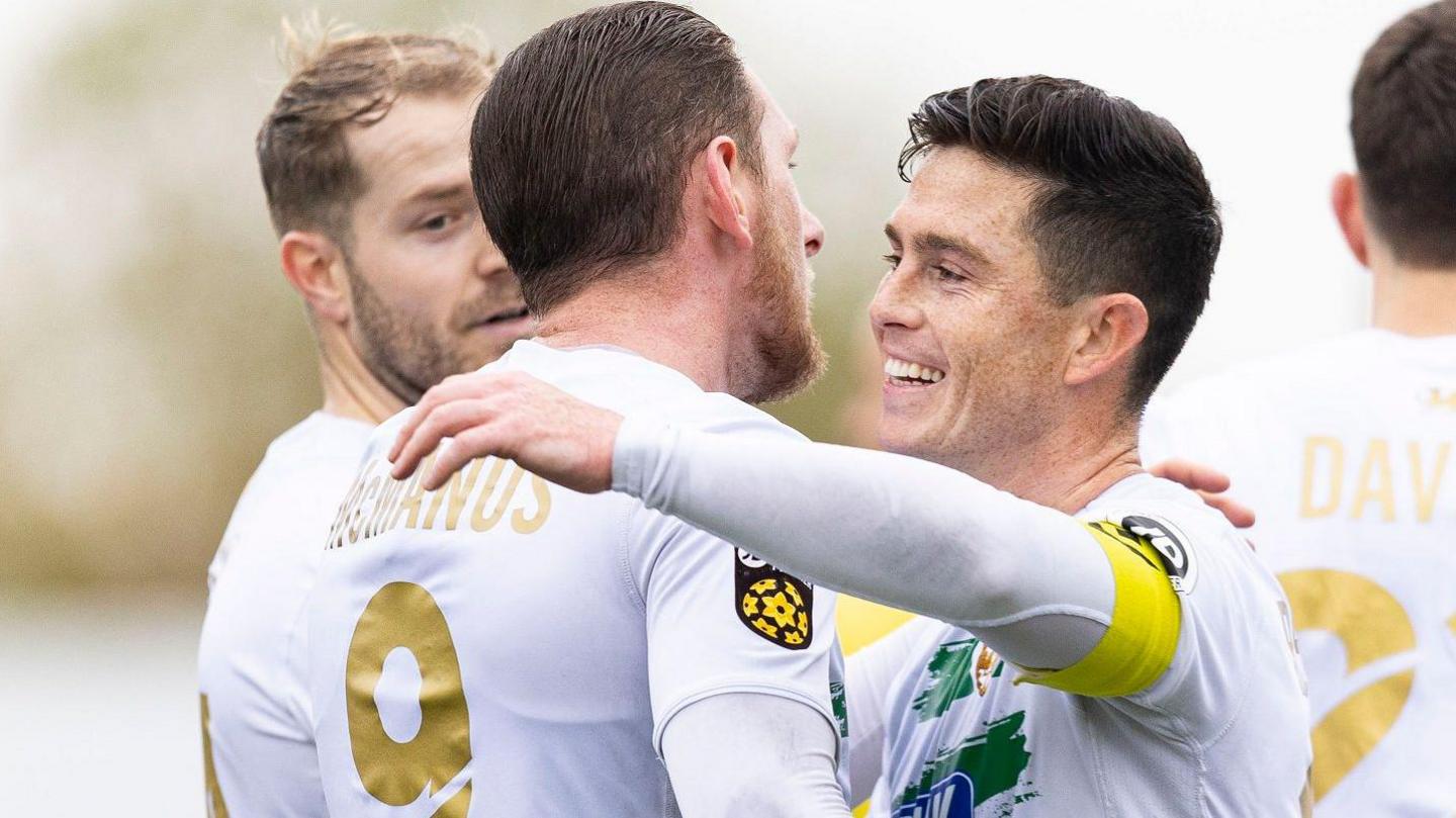 Declan McManus (L) celebrates at Barry