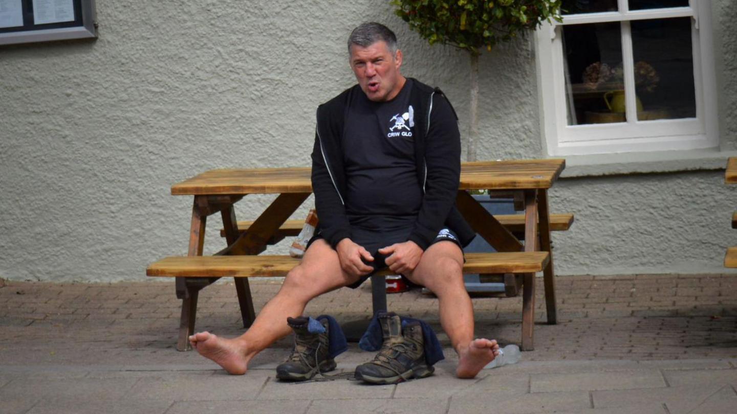 Derek Buton, un fu'n cyd-gerdded ac yn cefnogi ar y diwrnod yn cael hoe tu allan i'r Golden Lion yn Trefdraeth