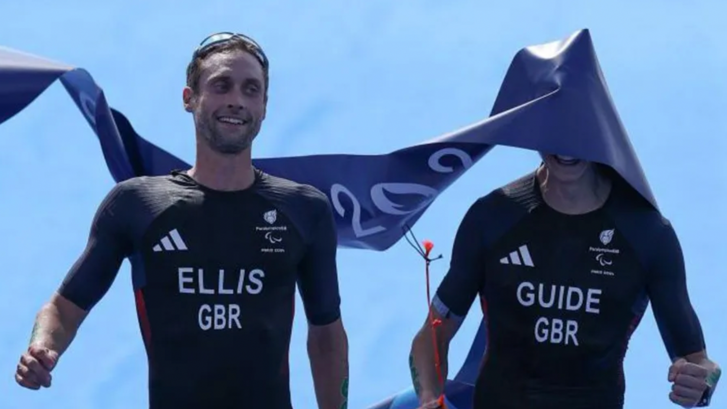 Dave Ellis and his guide Luke Pollard cross the finish line of the triathlon 