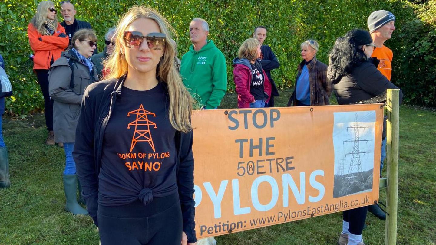 Portesters stand alongside a banner which reads "stop the 50 metre pylons".