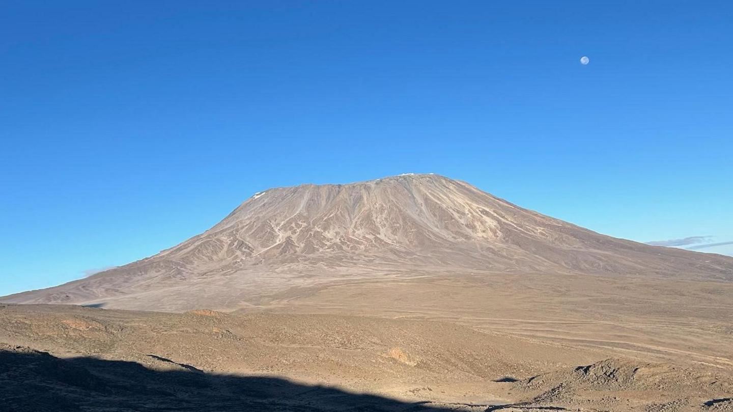 Kilimanjaro, a large rocky mountain with steep sides and a flat top.