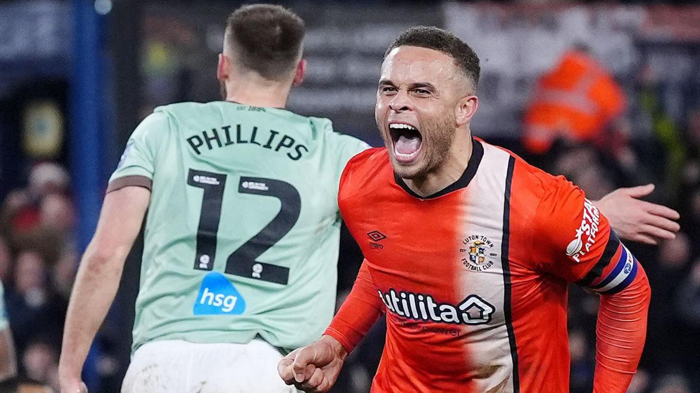 Carlton Morris celebrates after scoring Luton's winning goal against Derby