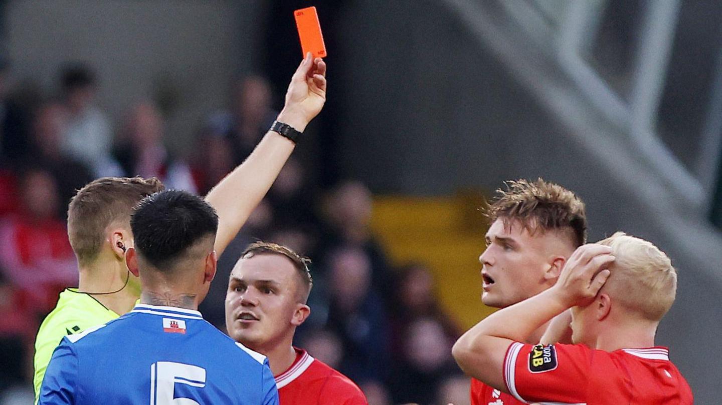 Odhran Casey is shown a red card
