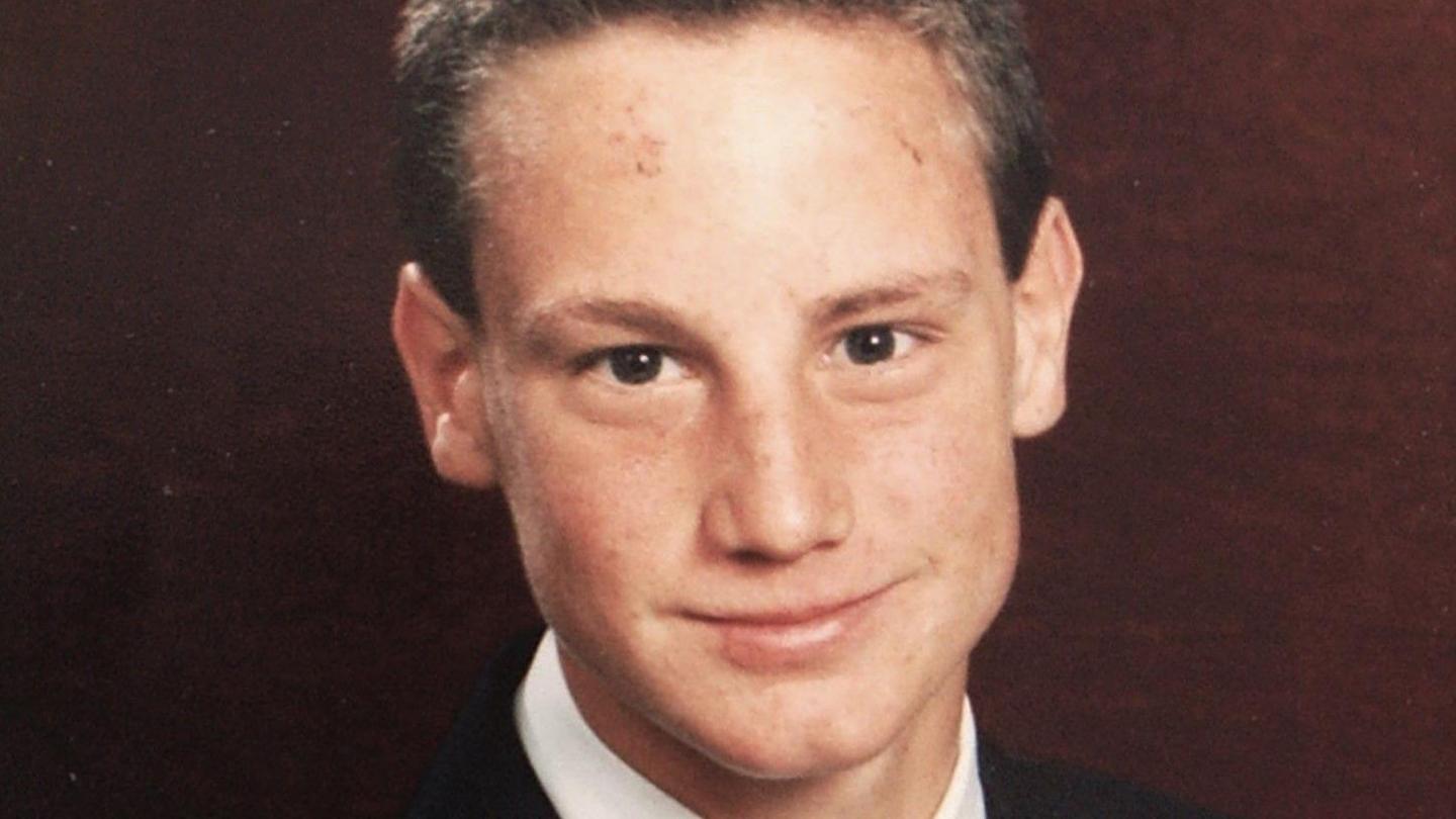 Steve Wyatt in school uniform smiling to camera