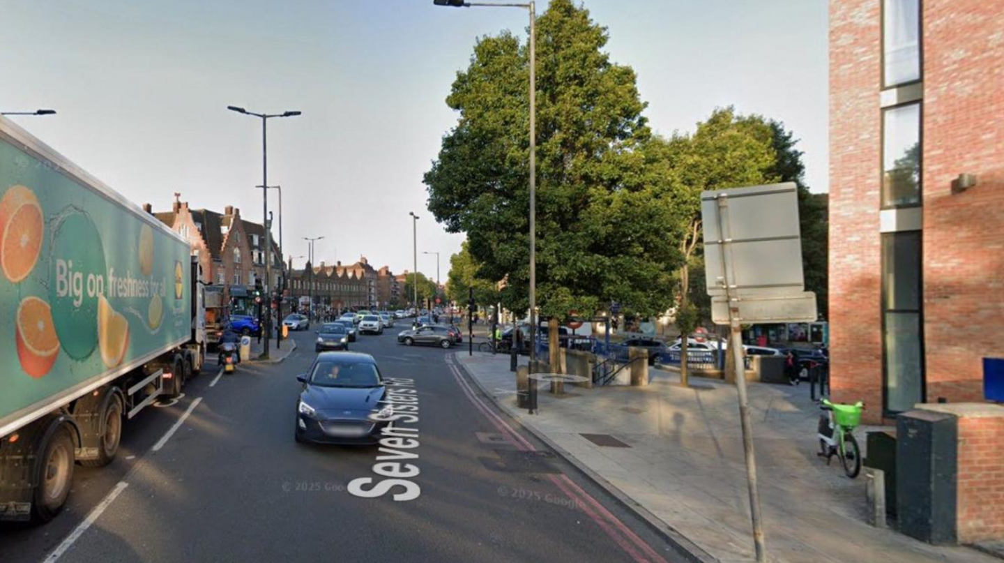 A Google Maps screen grab of the Seven Sisters Road with cars and lorries on the road and green trees on the pavement. 