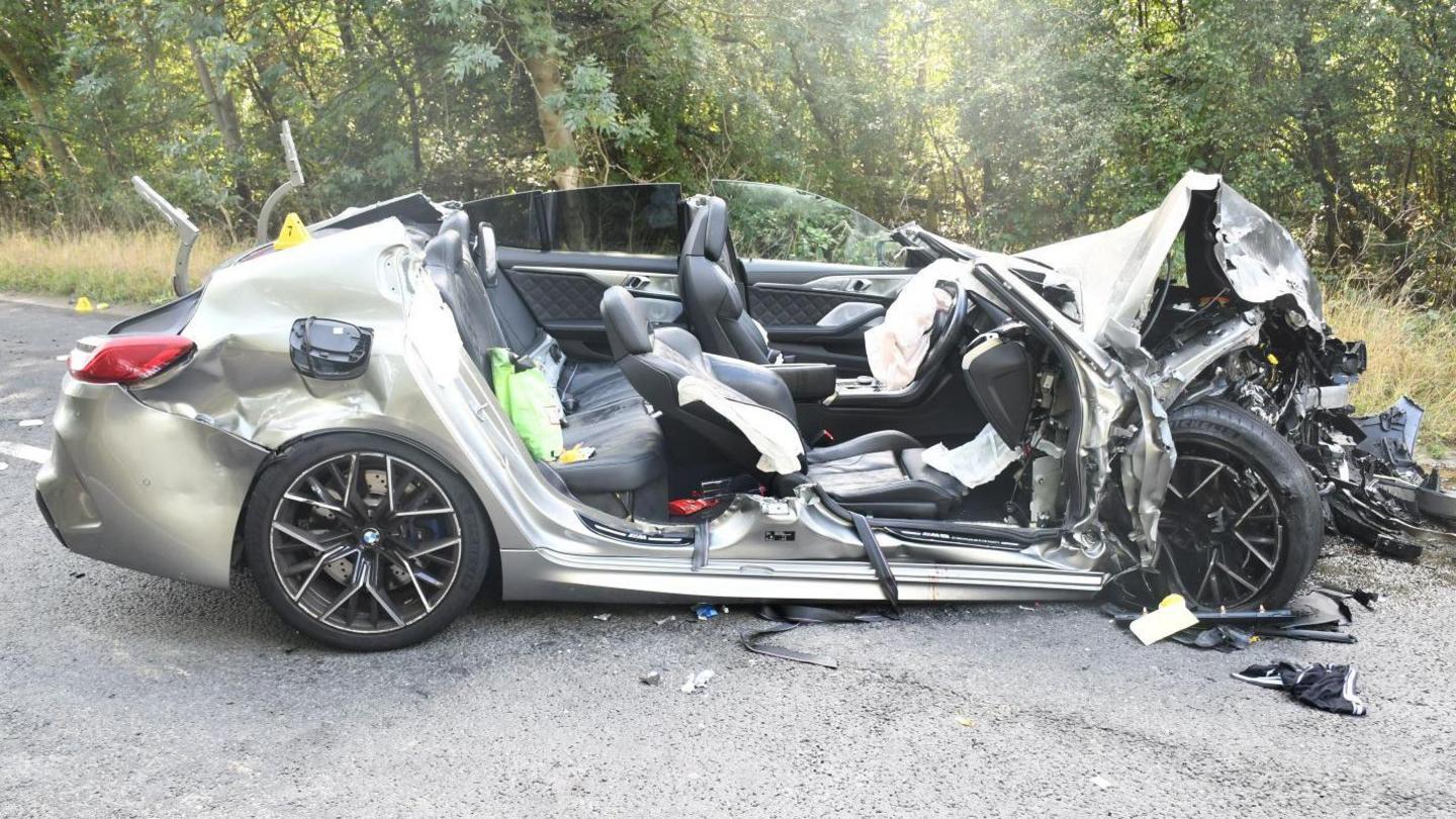 A seriously damaged silver BMW following a fatal crash