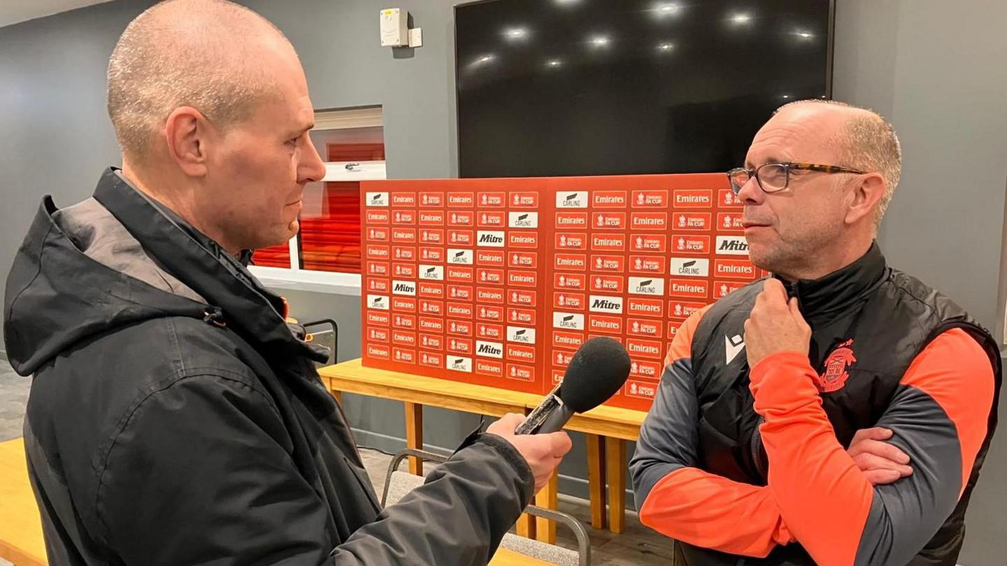 Lambs boss Andy Peaks is interviewed by BBC Radio WM's Mike Taylor in the Tamworth clubhouse