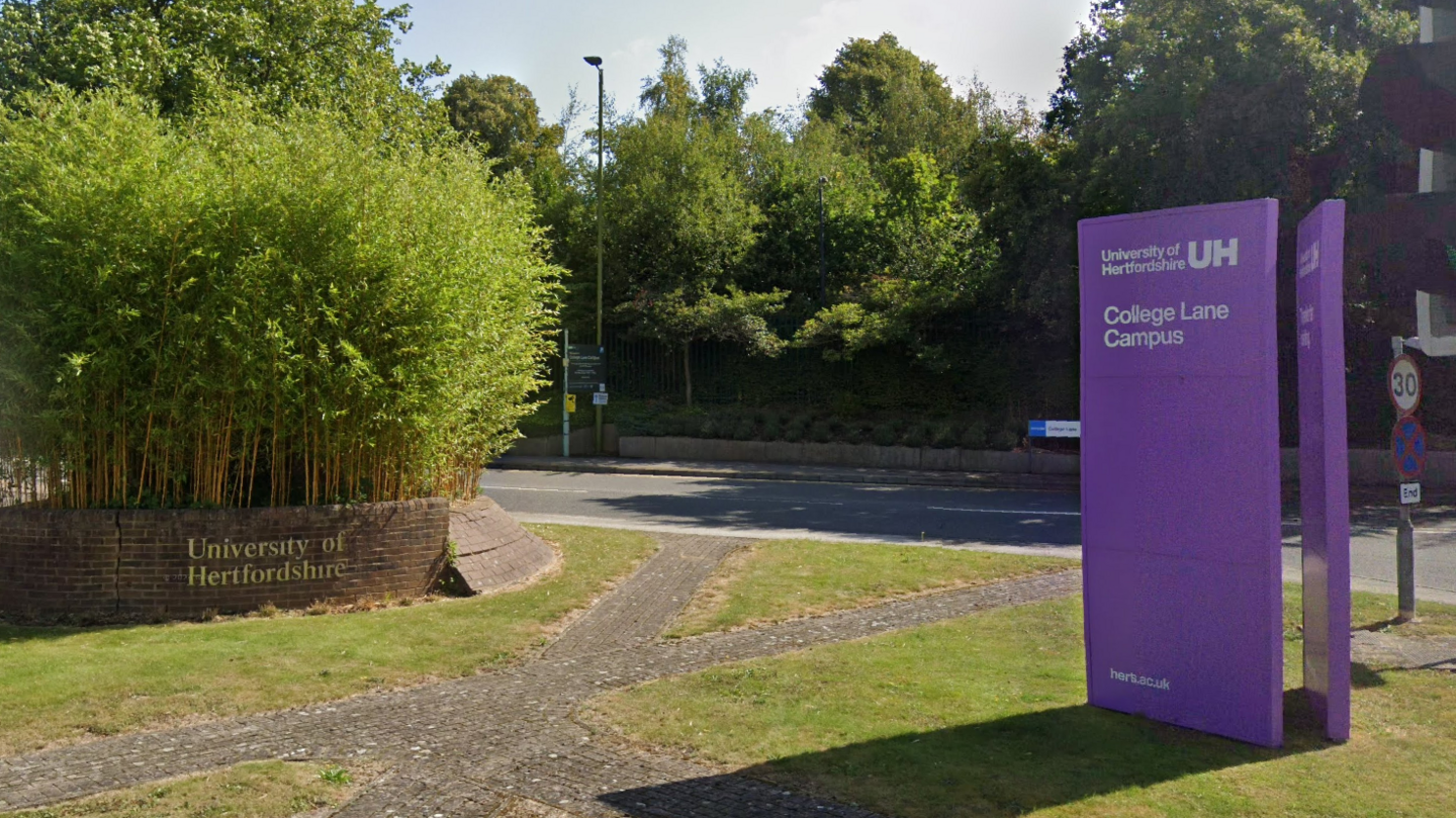 A view of the entrance to the University of Hertfordshire. A purple sign outside informs this is the College Lane Campus.