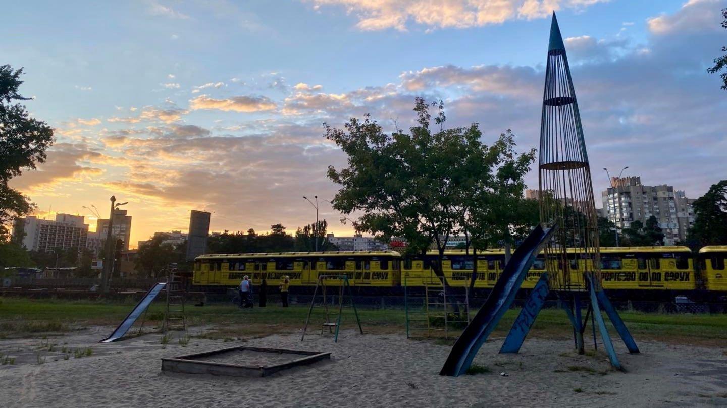 An ex-Soviet play park in Kyiv, with a rocket shaped slide in the foreground.