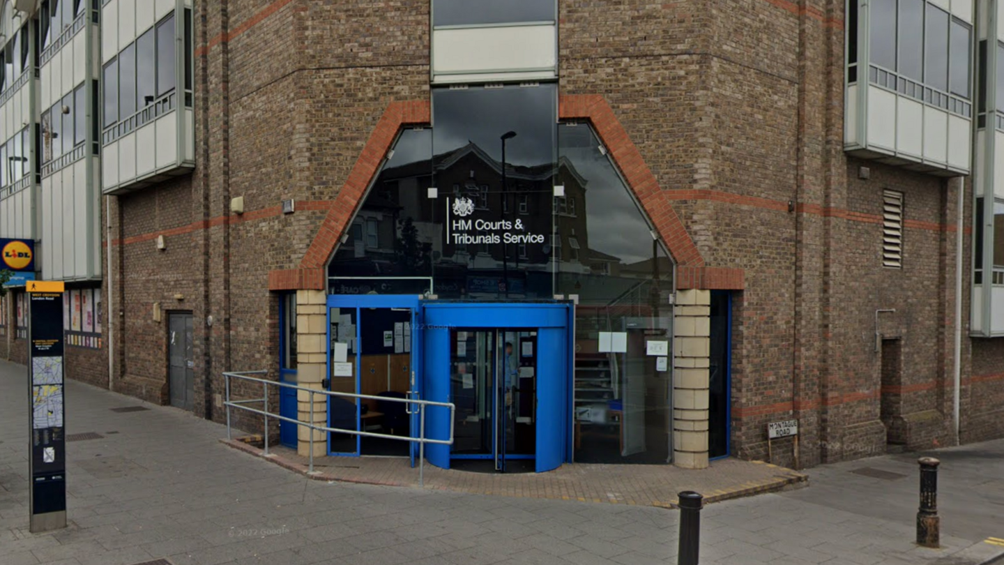 Exterior of south London tribunal brick building with clue door and sign above reads 'HM Courts and Tribunals Service'