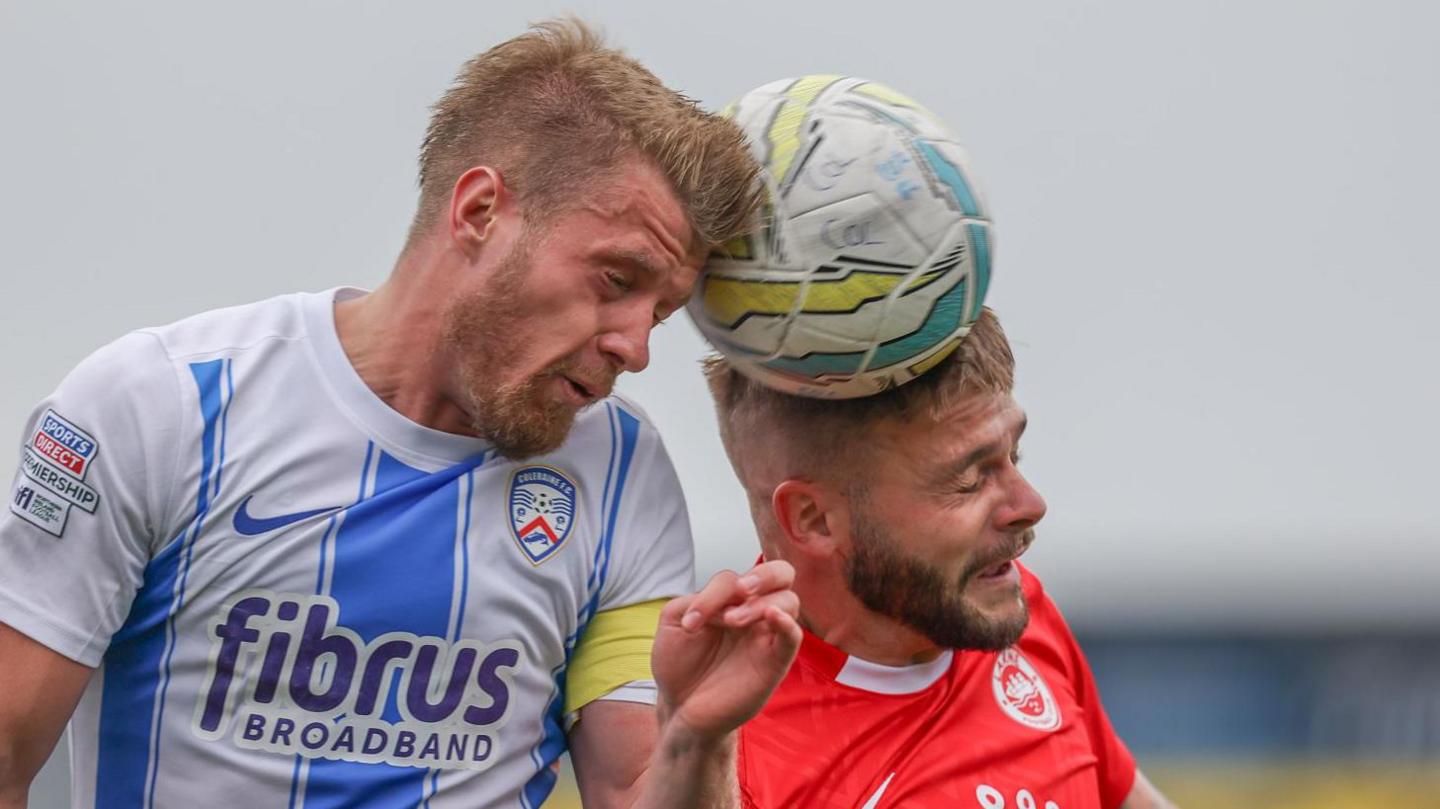 Coleraine skipper Lyndon Kane and Andy Ryan compete for the high ball