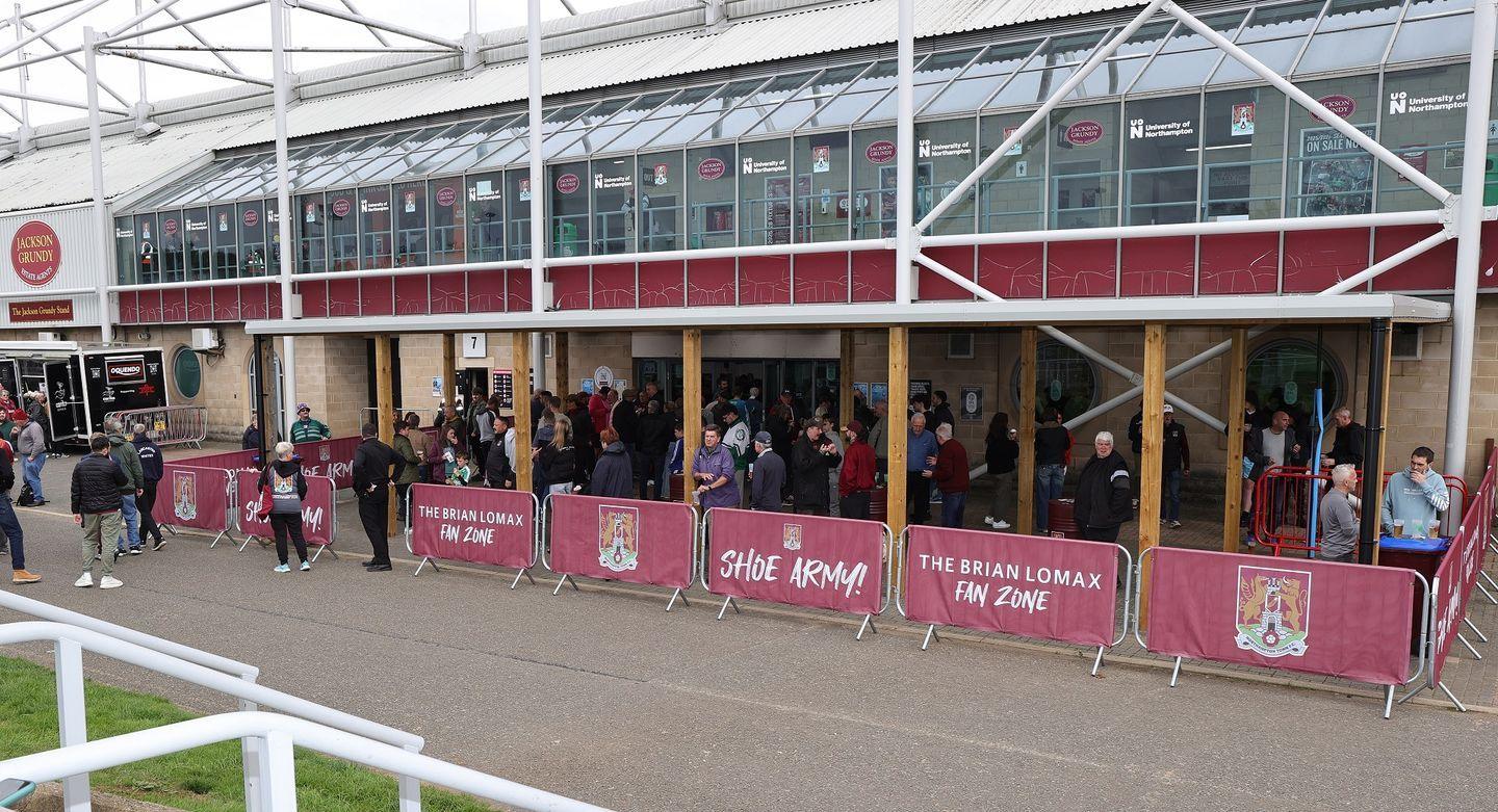 Fans gather at the Brian Lomax Fan Zone which is fixed to the rear of the West Stand at Sixfields Stadium.
