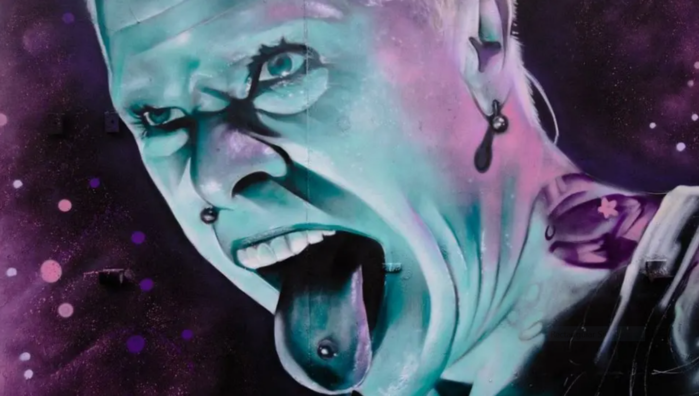 A close-up of David Nash's Keith Flint mural - a purple and blue painting showing Keith shouting with his pierced tongue sticking out.