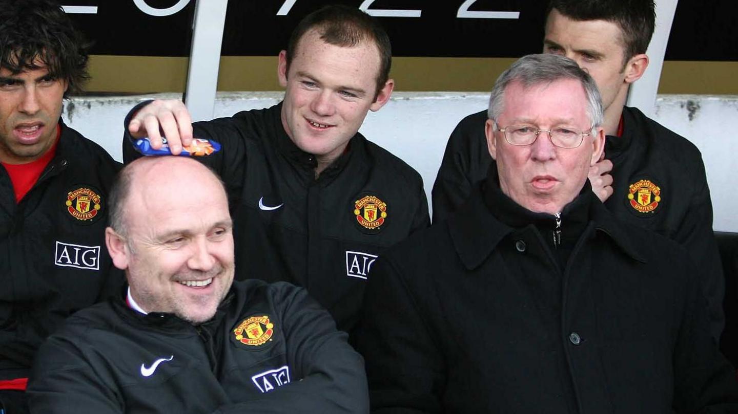 Wayne Rooney and Mike Phelan share a joke alongside Si Alex Ferguson in the Manchester United dugout