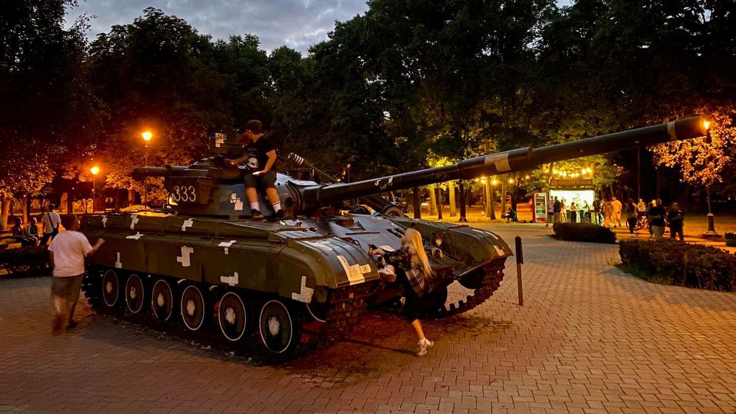 Children play on an out-of-service tank in Kyiv