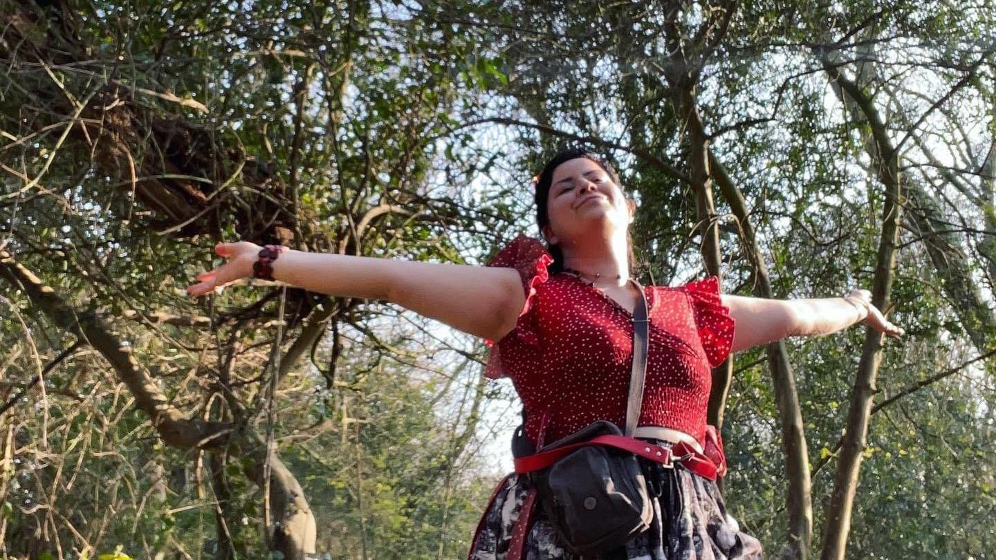 Siân Powell in a red top in a forest