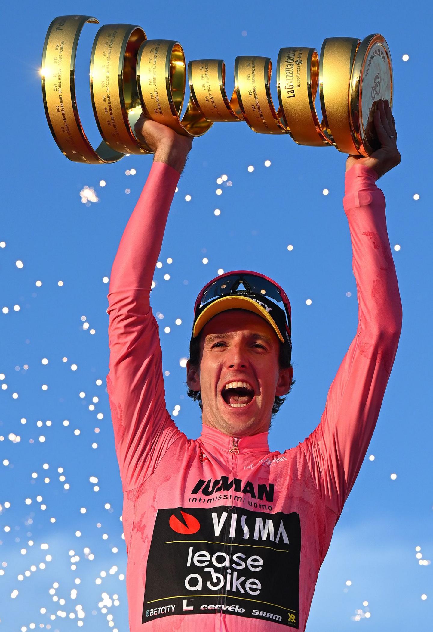 Great Britain's Simon Yates celebrates at podium as Pink Leader Jersey winner with the Trofeo Senza Fine during the 108th Giro d'Italia 2025 in Rome, Italy. Photo by Tim de Waele