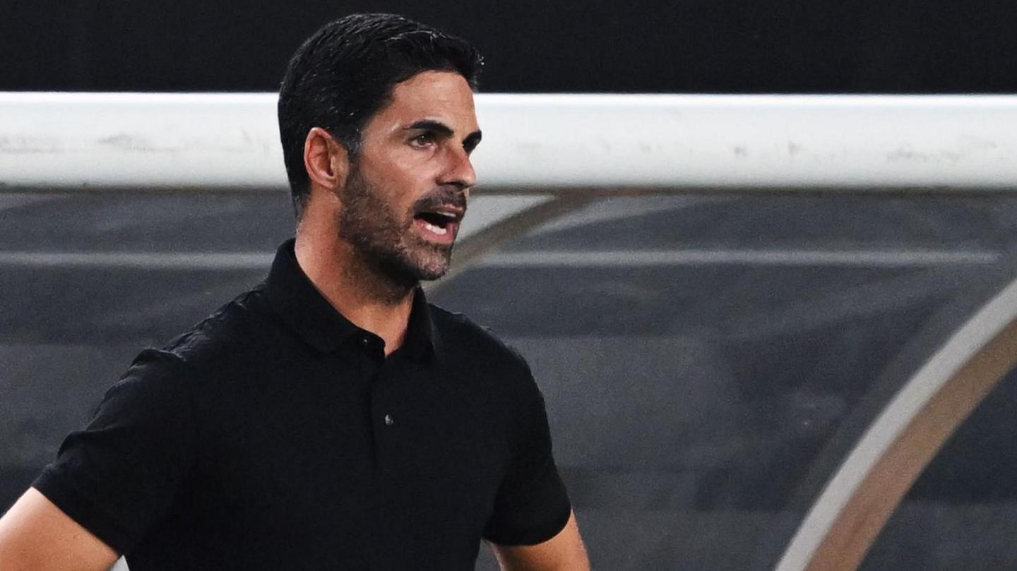 Mikel Arteta stands on the touchline