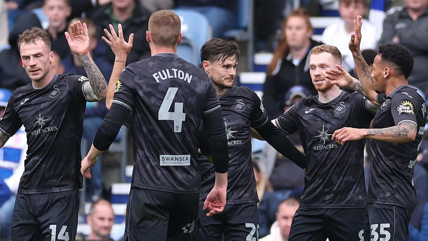 Swansea players celebrate their opening goal