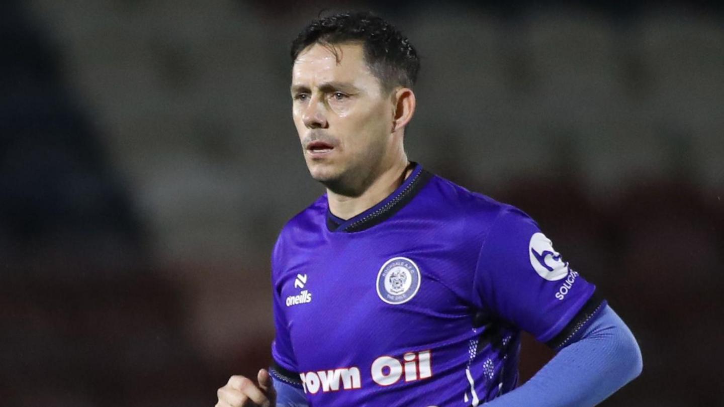 Ian Henderson playing for Rochdale last season during a midweek game 