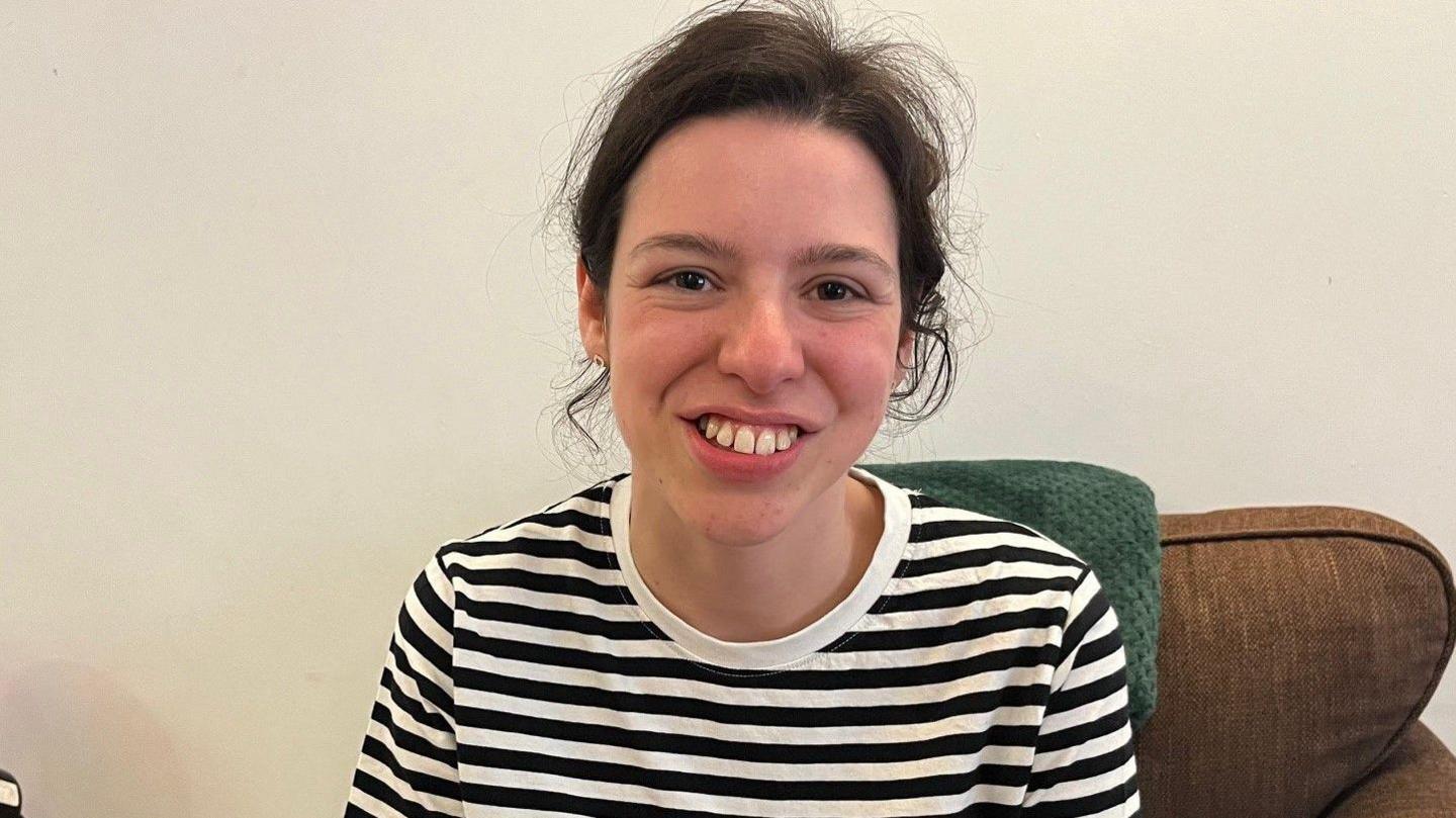 A young woman smiles for the camera