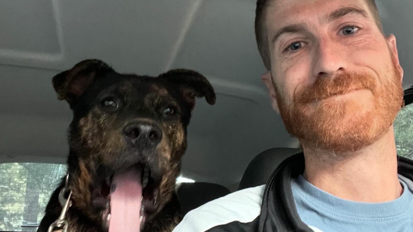 Blaine Bacher, an evacuee of the California wildfires, with his dog