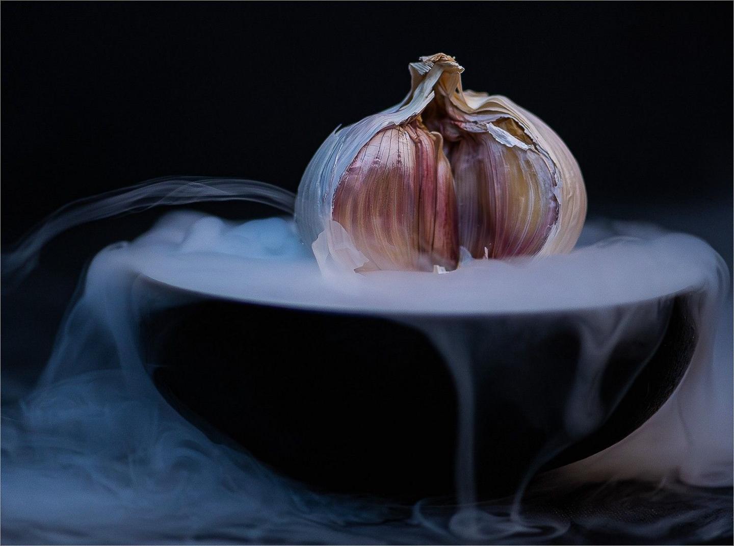 A bulb of garlic surrounded by dry ice