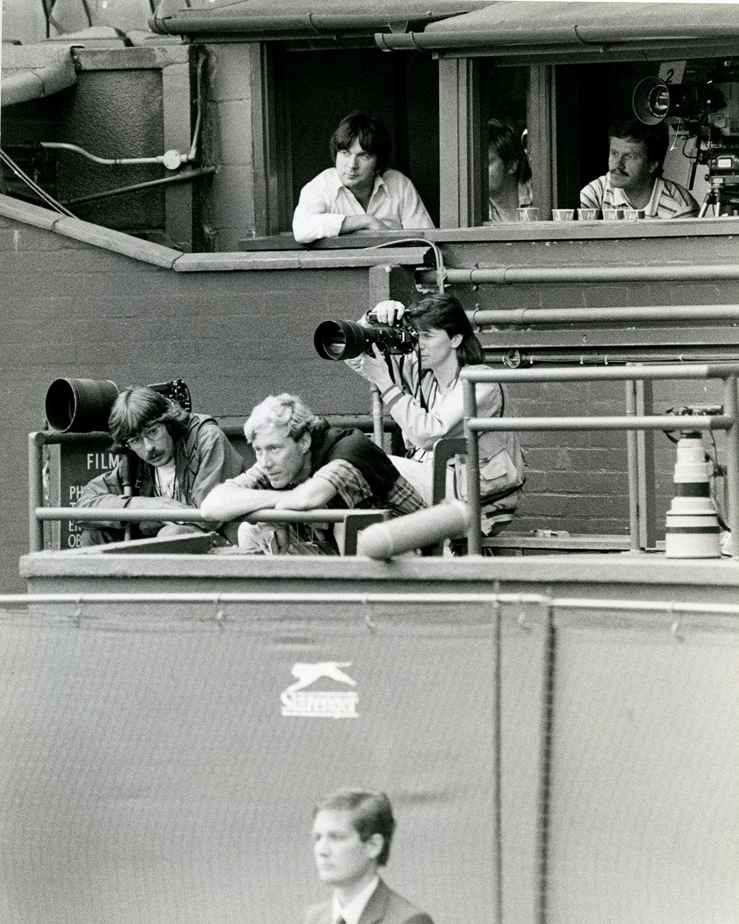 Black and white photo of Eileen shooting at Wimbledon from the photo gantry in 1984.