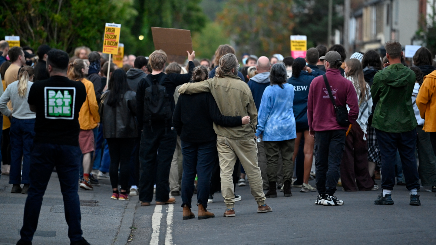 A couple embraced in Oxford outside the Asylum Welcome immigration support service office