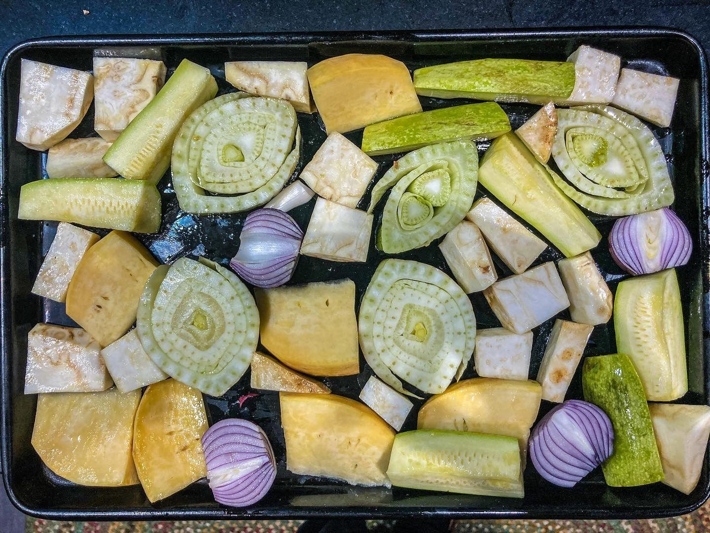 A selection of vegetables cut and prepared in a baking tray