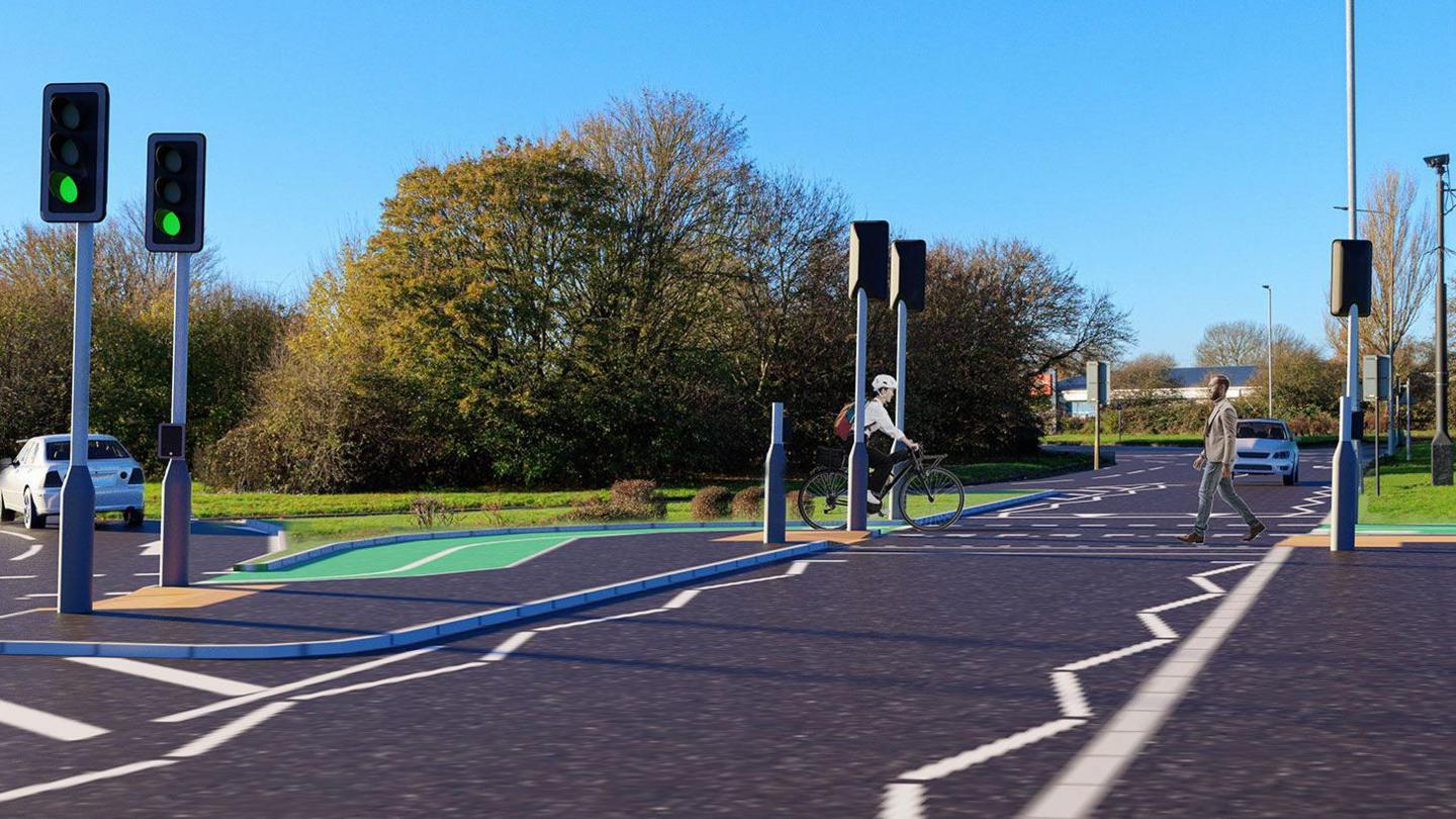 An illustration showing one person on a cycle and another person crossing at a pedestrian and cycle crossing. There are traffic signals. Trees and grass surround the road. There are cycle lanes. There are two cars.