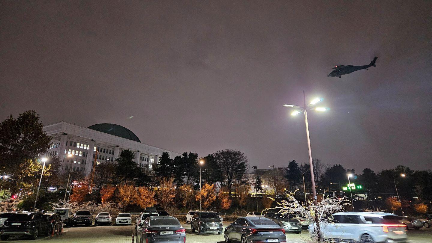 A helicopter flies around the National Assembly hall