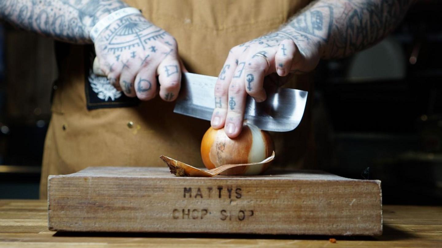 A close up of Matt O'Brien chopping in his kitchen 