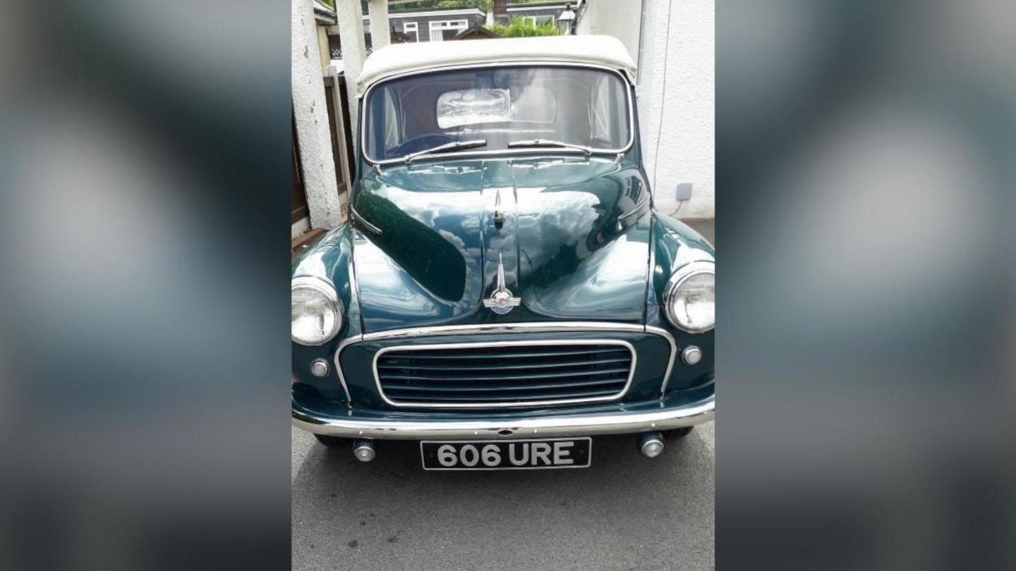 A black 1958 Morris Minor Convertible