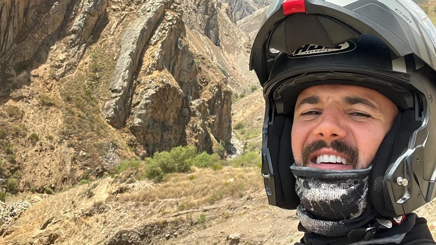 Luke Tarrant wearing a motorbike helmet