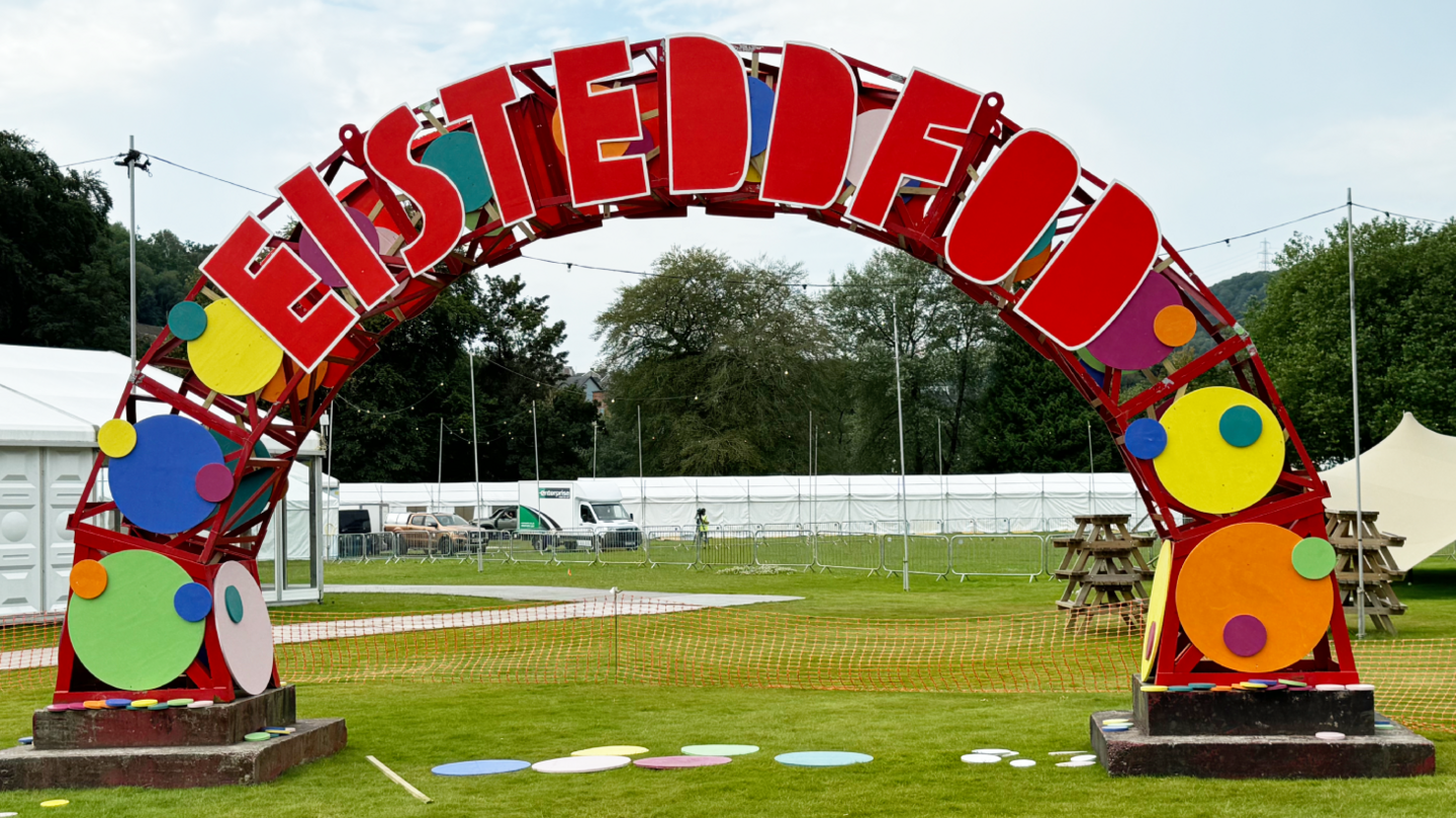 Large curved eisteddfod sign in Ynysangharad Park, Pontypridd.