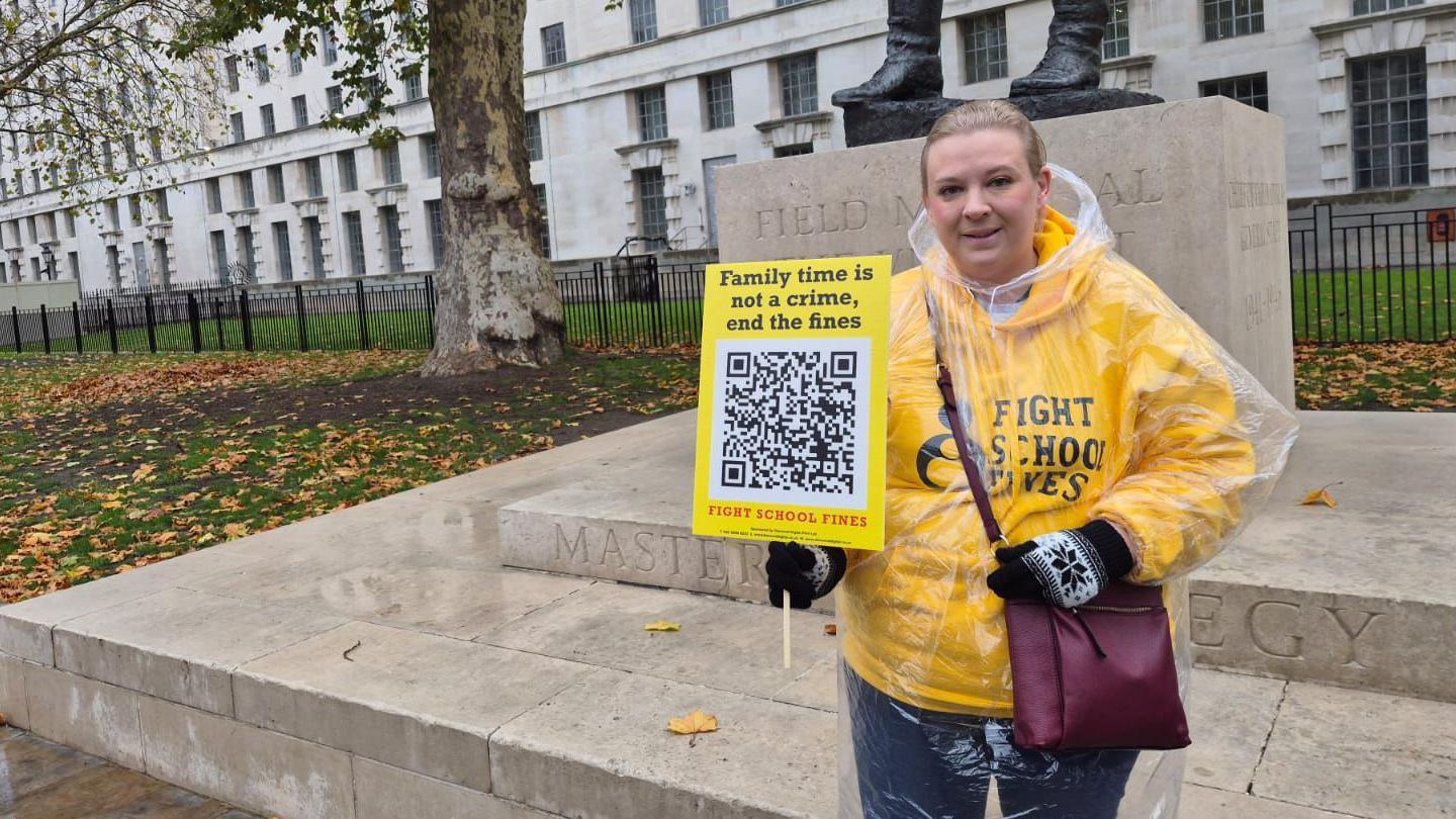 Woman holding sign for a rally 