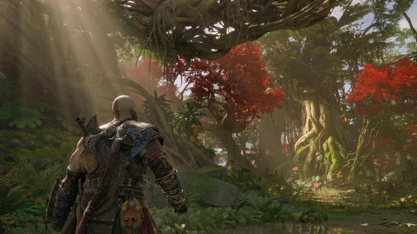 A bald character clad in leather armour and with a large axe on his back walks into a forest scene. It's realistically illuminated with shafts of sunlight breaking through the canopy of the trees.