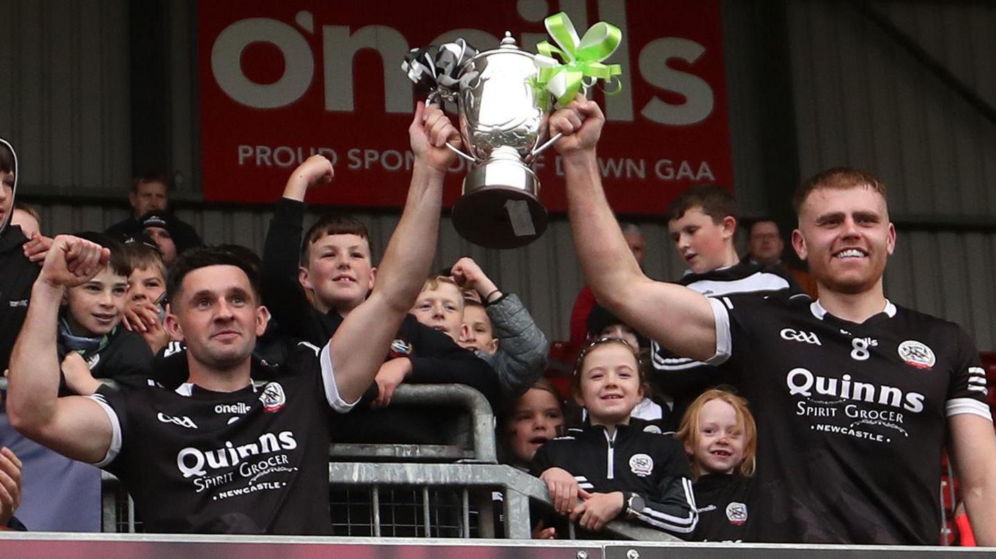 Kilcoo's Daryl Branagan and Aaron Morgan lift the Frank O'Hare Cup at Pairc Esler