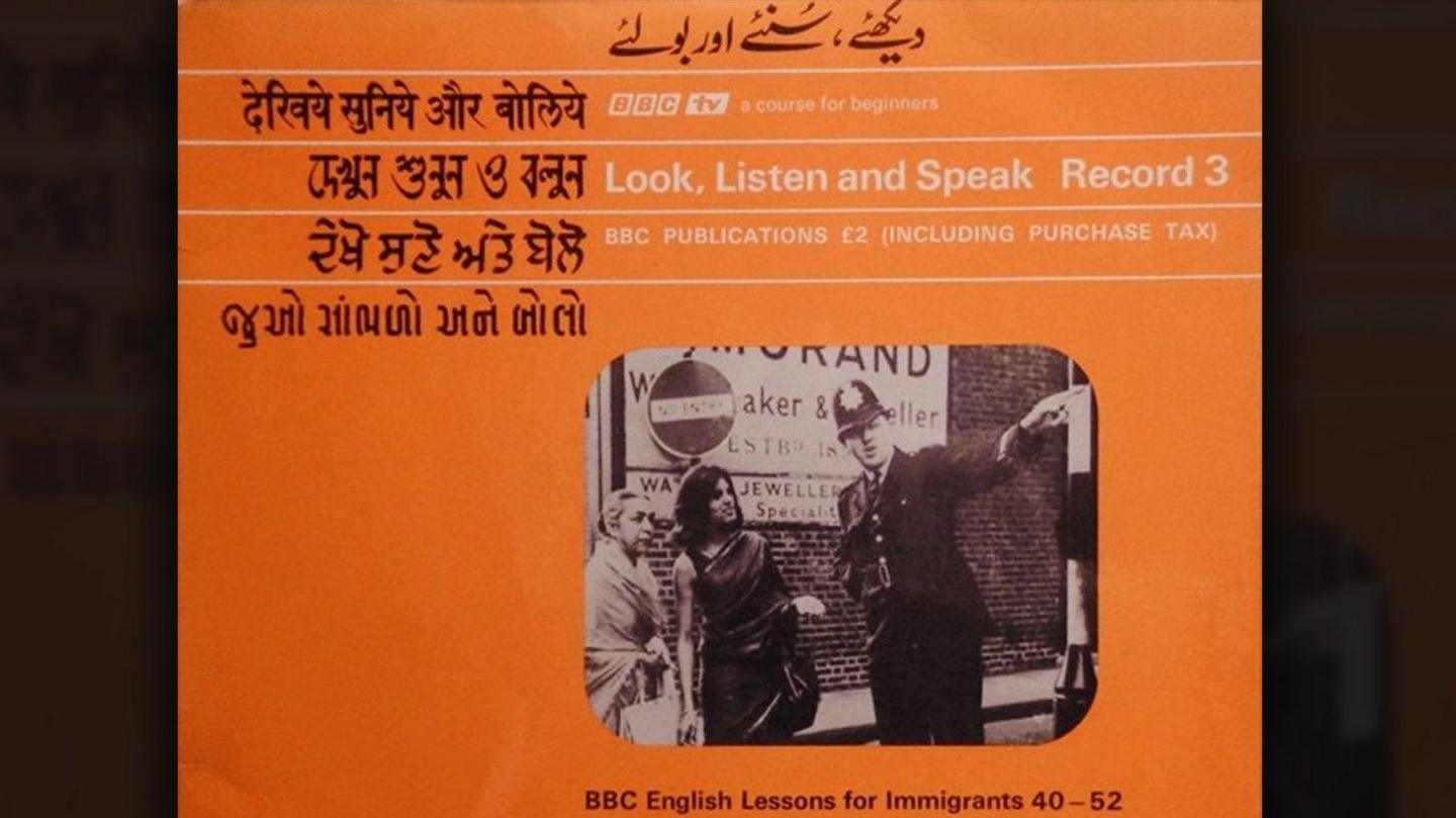 A agleam  orangish  LP screen  shows the rubric  Look, Listen and Speak successful  Bengali, English, Gujarati, Hindi, Punjabi and Urdu. This is an English connection   tv  people   produced by the BBC successful  the precocious   1960s, designed to assistance   South Asian immigrants larn  basal  English, accommodate  to British culture, and integrate into beingness  successful  the UK.  In the centre of the screen  is simply a black‑and‑white photograph  of a constabulary  serviceman  talking to 2  radical   connected  a street.
