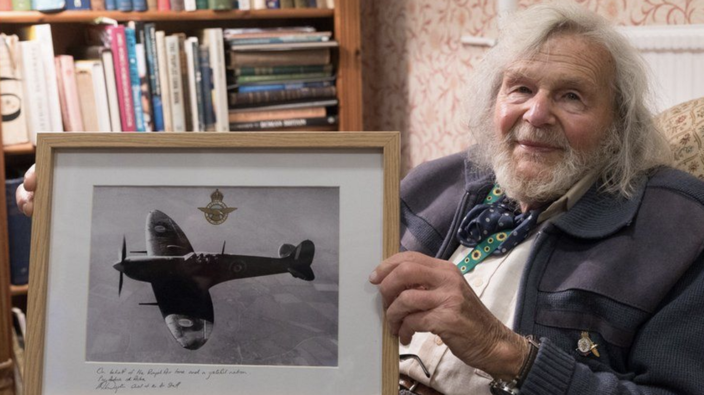 Dr Edmund James with a Spitfire photo to replace the one that was stolen from him