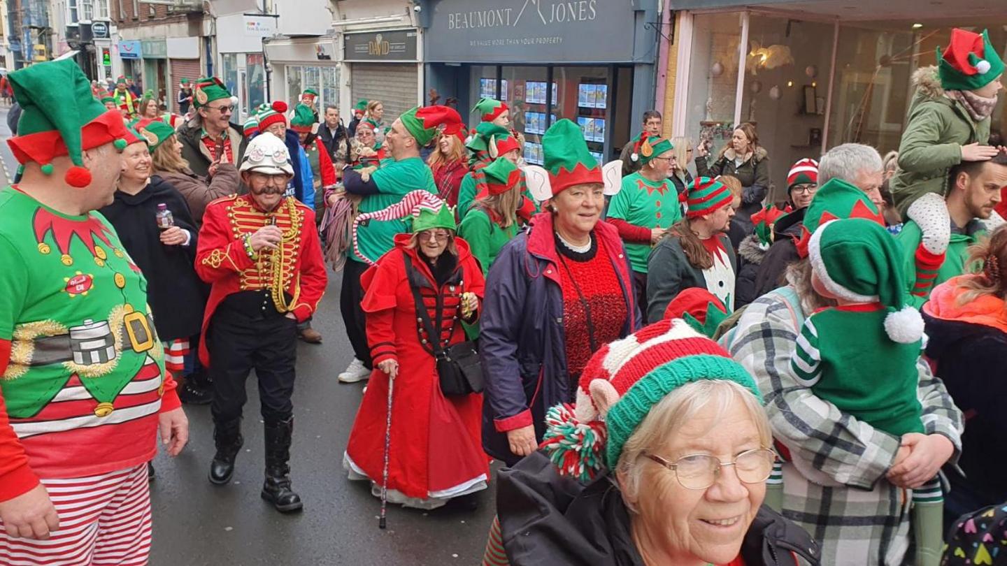 A parade of people dressed as elves