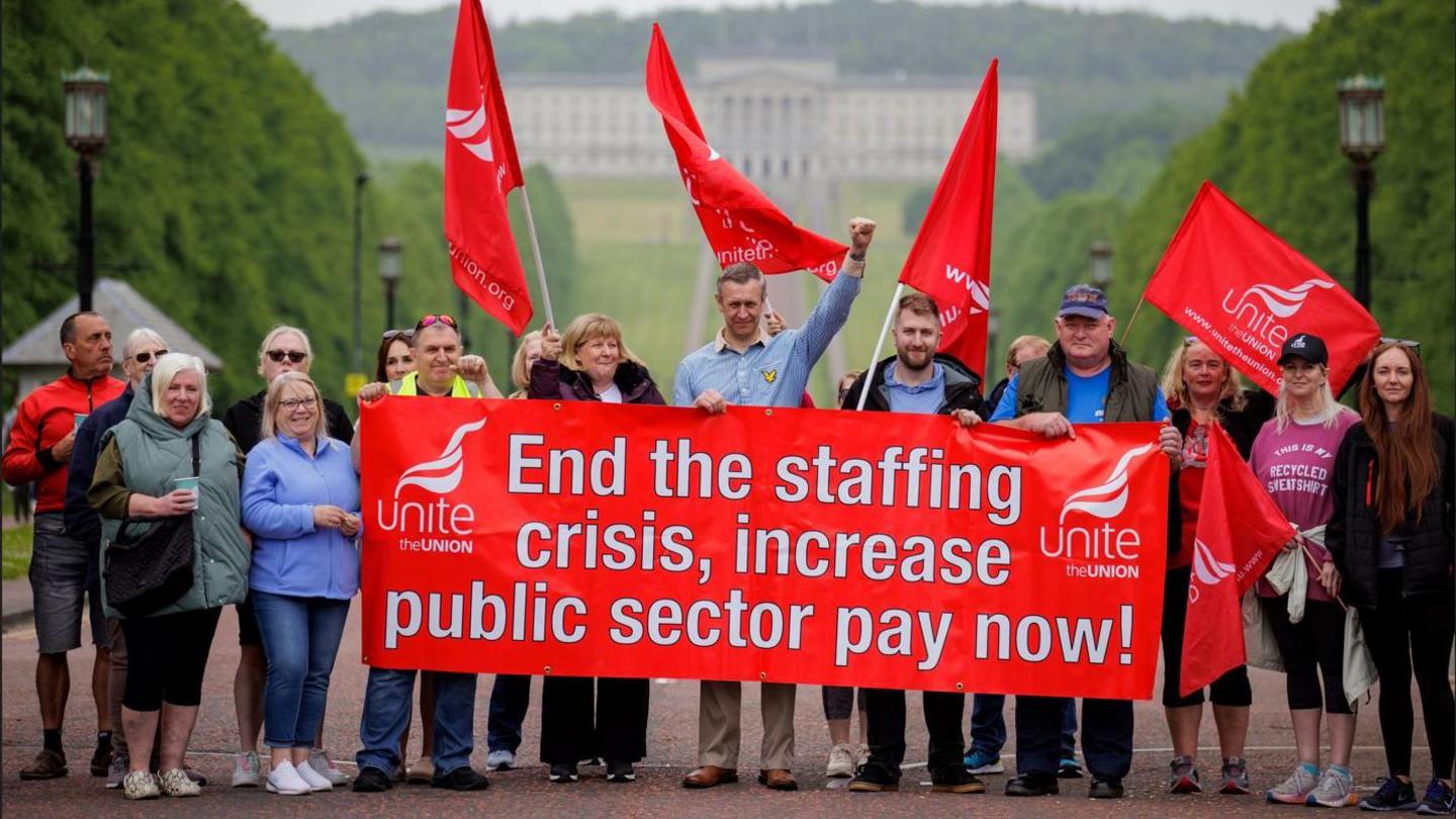 Members of the Unite union protest outside Stormont