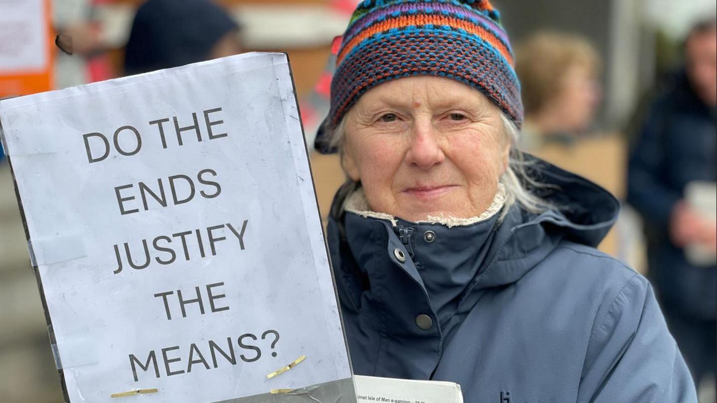 Deborah Taubman holding a sign