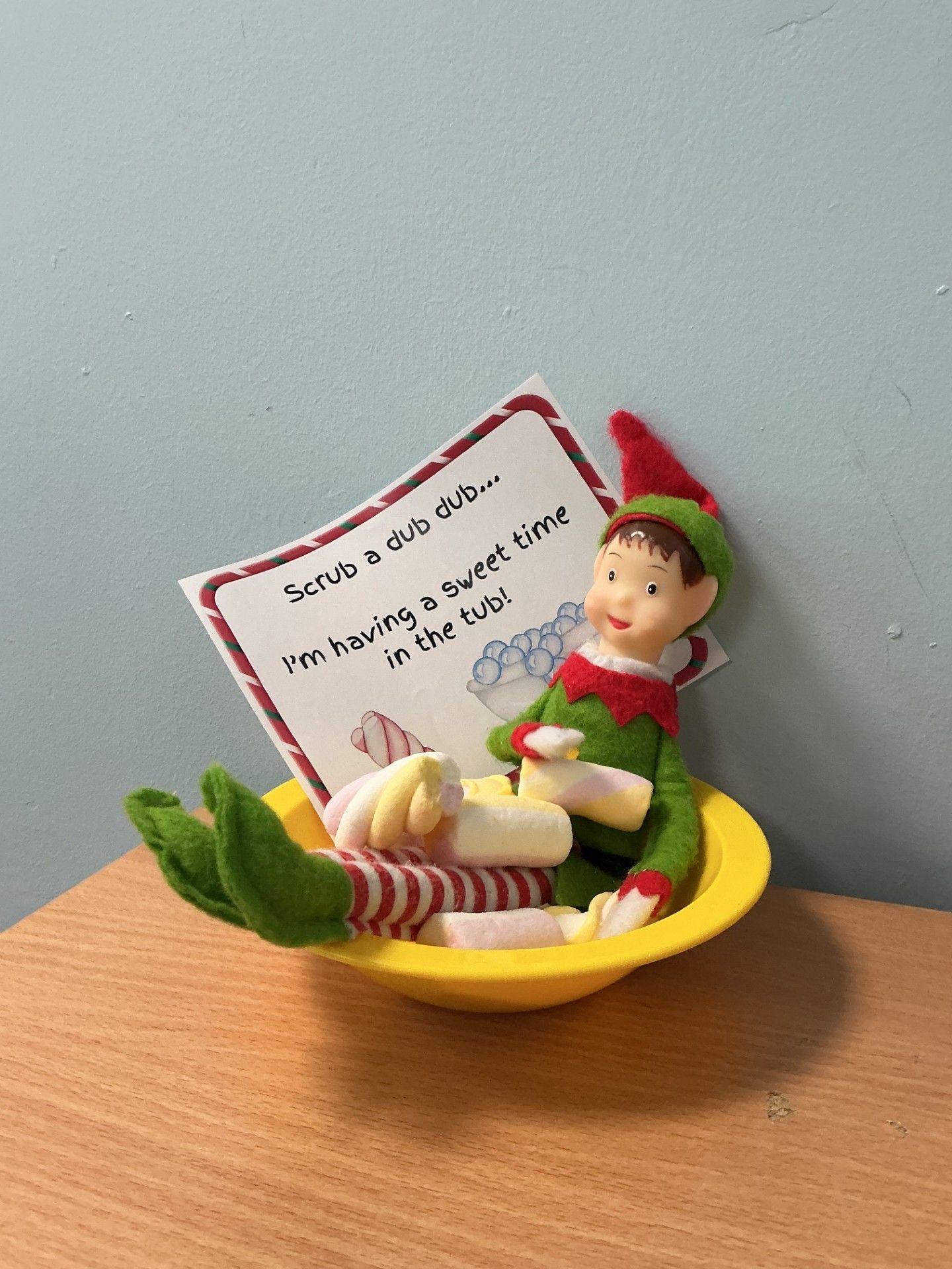 Elf is shown in a yellow platic bowl covered in marshmallows with a note saying 'scrub a dub dub, I'm having a sweet time in the tub'! 