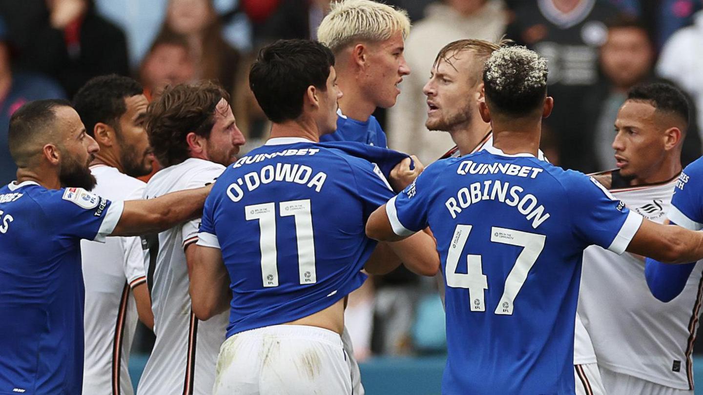 Cardiff City and Swansea City players tussle during the most recent south Wales derby fixture at the Swansea.Com Stadium