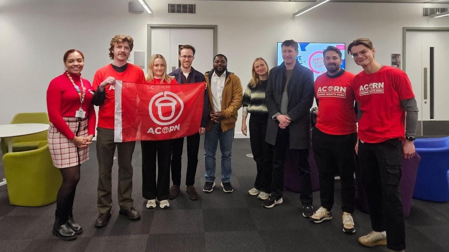 Members of ACORN Southwark with Labour councillors - standing together with red ACORN banners