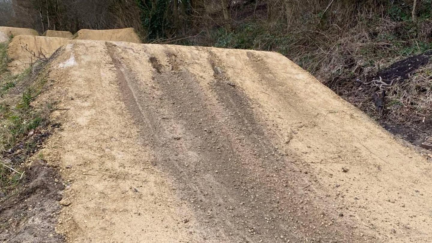 A BMX track with ruts left in the ground.