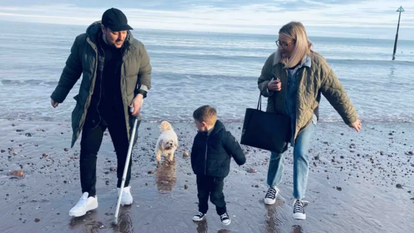 Justin with his wife and son at the beach